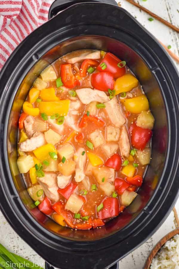 overhead of crockpot sweet and sour chicken in a slow cooker