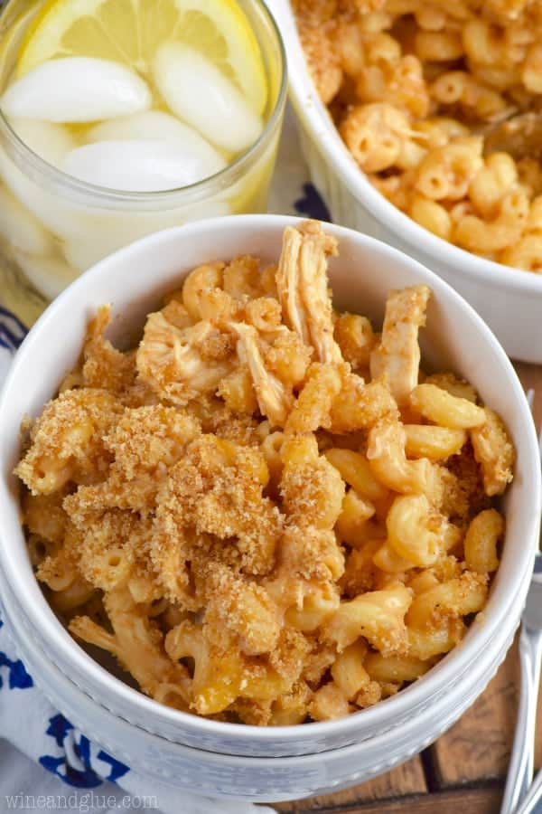 In a white bowl, the BBQ Chicken Macaroni and Cheese has breadcrumbs and chicken mixed in. 
