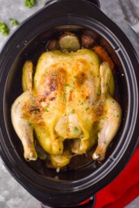 overhead view of a crockpot whole chicken in a slow cooker