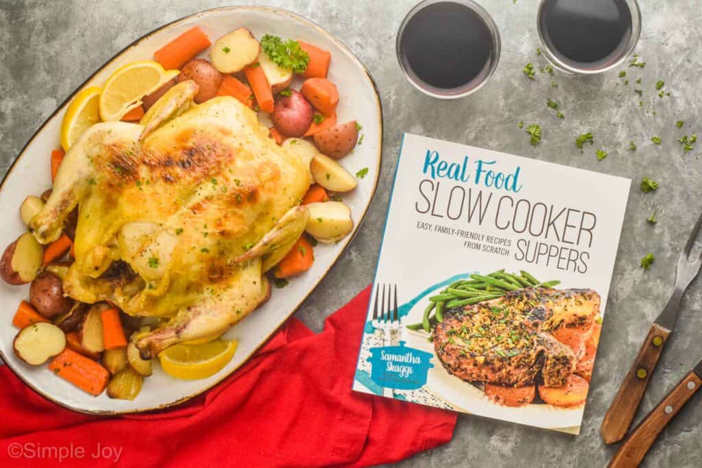 overhead view of a cookbook next to a whole chicken