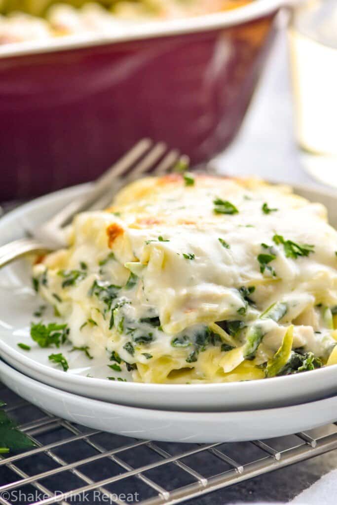 side view of a piece of white lasagna recipe on two stacked plates