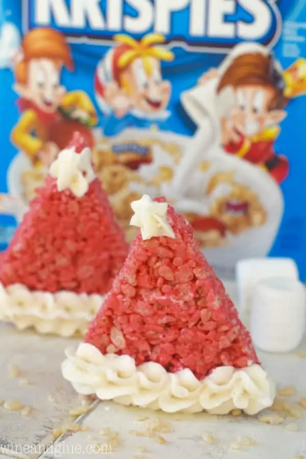In front of the Rice Krispies cereal box, the Rice Krispies Santa Hat is red with white frosting piped on the tip and at the bottom. 