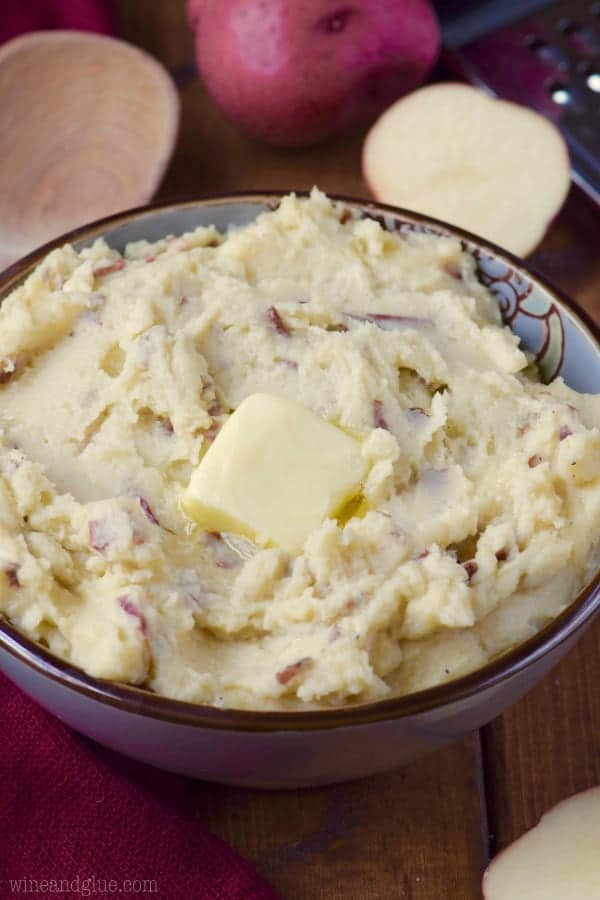 In a purple blow, the Cheesy Crock Pot Mashed Potatoes has a single slice of butter. 