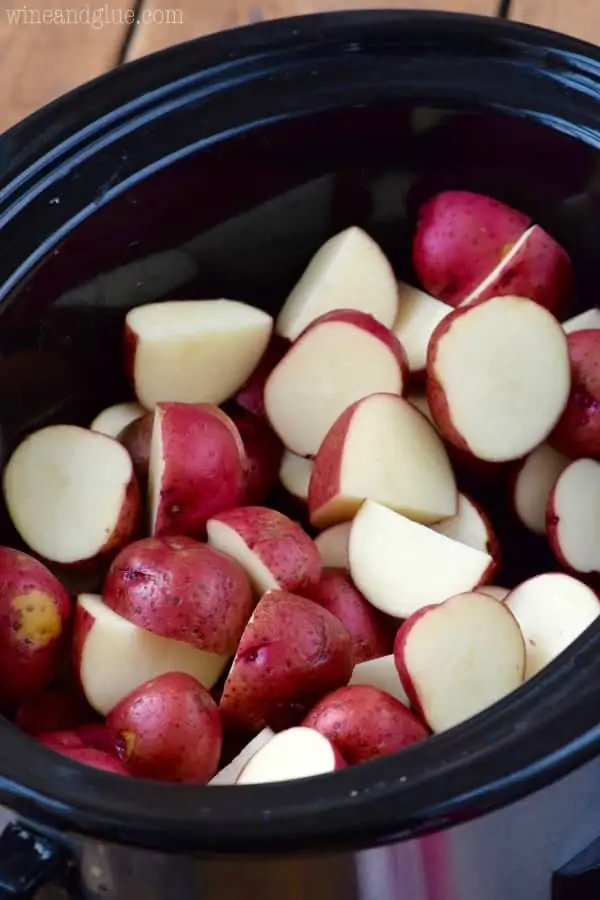 Sliced up red potatoes fill up the crock pot. 