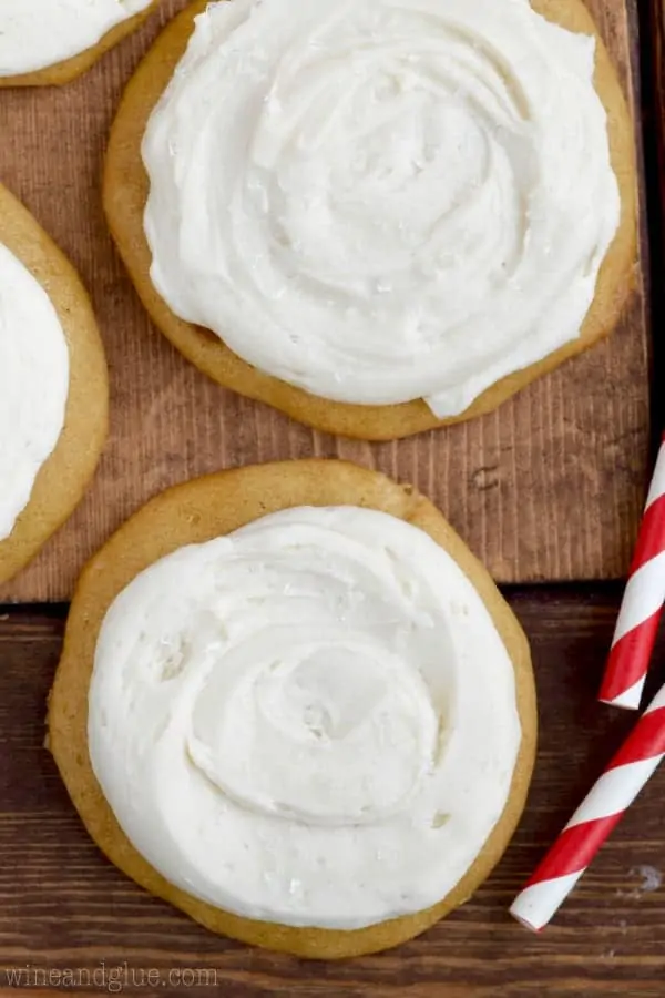 An overhead photo of the Coca-Cola Cookies that has darker color than sugar cookies and white Coca-Cola Frosting. 