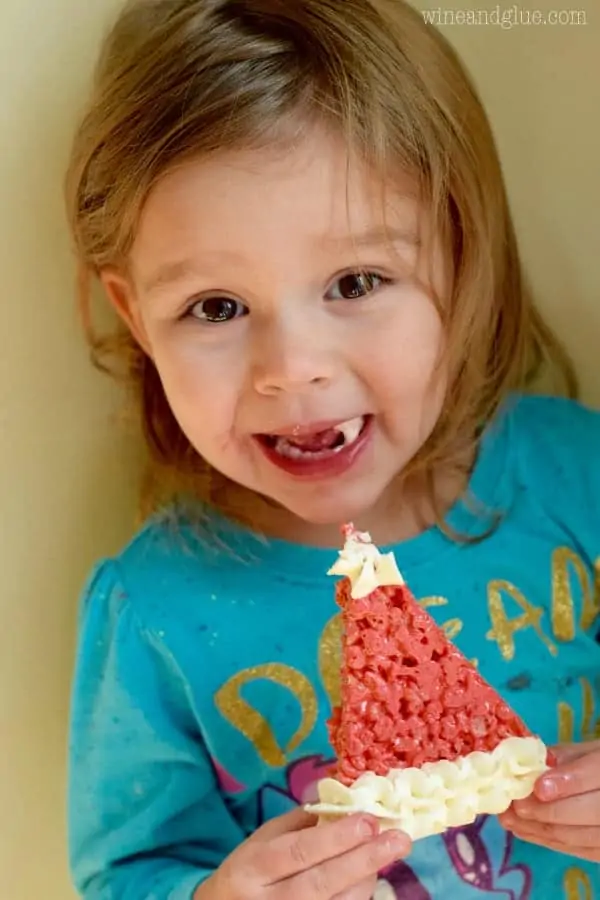 A little girl eating the Rice Krispies Santa Hat. 