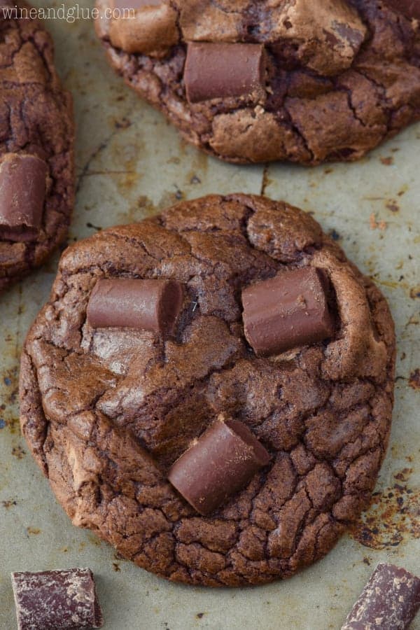 An overhead photo of the Triple Chocolate Chunk Cookies with three large chocolate chunks and a hard exterior. 