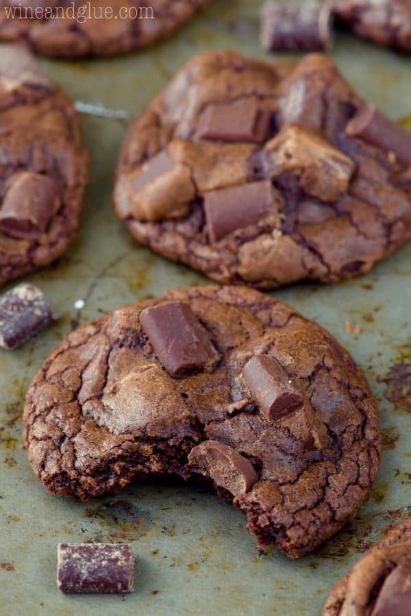 On a baking pan, the Triple Chocolate Chunk Cookie has a little bite showing the moist interior. 