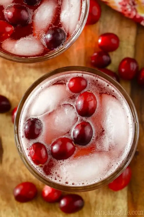 An overhead photo of the Cranberry Vodka Press mixed in with ice and whole cranberries. 