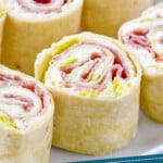 pinterest graphic of close up of an italian pinwheel on a plate, says: "tried & tested italian pinwheels simplejoy.com"