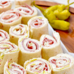 pinterest graphic of rectangular plate with three rows of italian pinweels on it, says: amazing italian pinwheels simplejoy.com