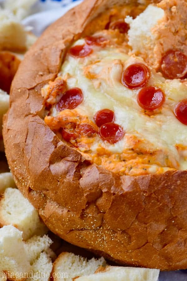 The Bread Bowl Pizza Dip has a hole in the middle of the bread filled with pizza sauce, melted cheese, and topped with mini pepperoni. 