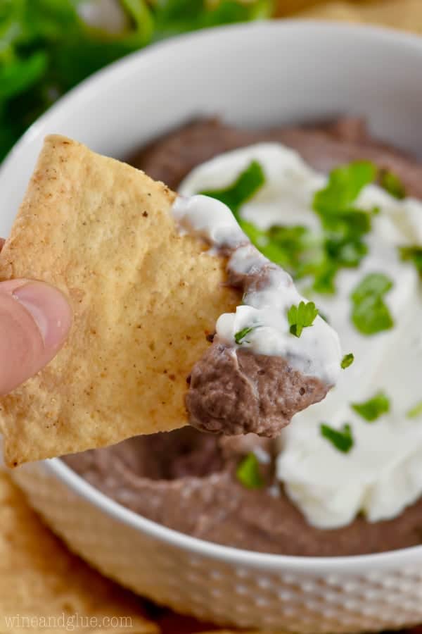 On the tip of the chip, half of the tip has the Black Bean Dip and the other half is sour cream. 