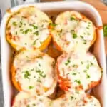 overhead of stuffed pepper recipe in a white casserole dish and garnished with fresh parsley