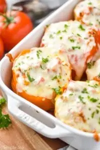 close up of a orange Italian stuffed pepper in a casserole dish