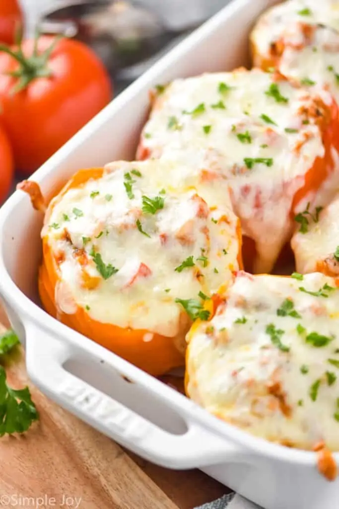 close up of a orange Italian stuffed pepper in a casserole dish 