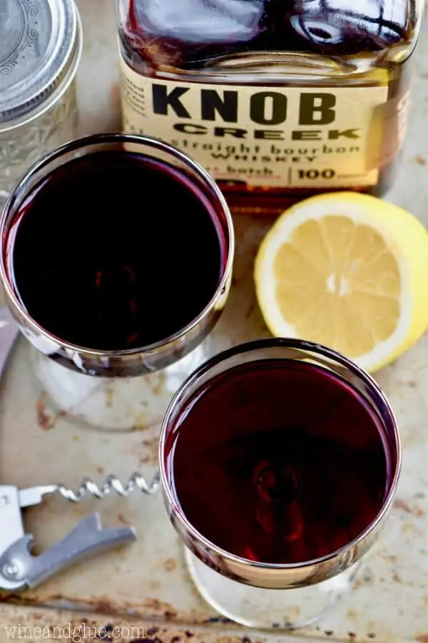 An overhead photo of the Whiskey and Wine Cocktail that are in long necked glasses. 