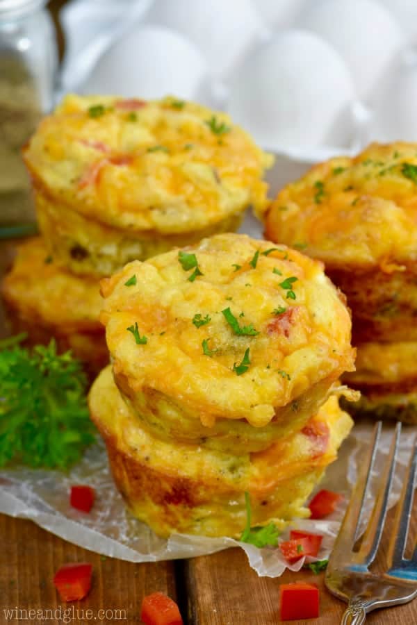 The Cheese and Sausage Egg Muffins are stacked on top of each other and topped with parasley