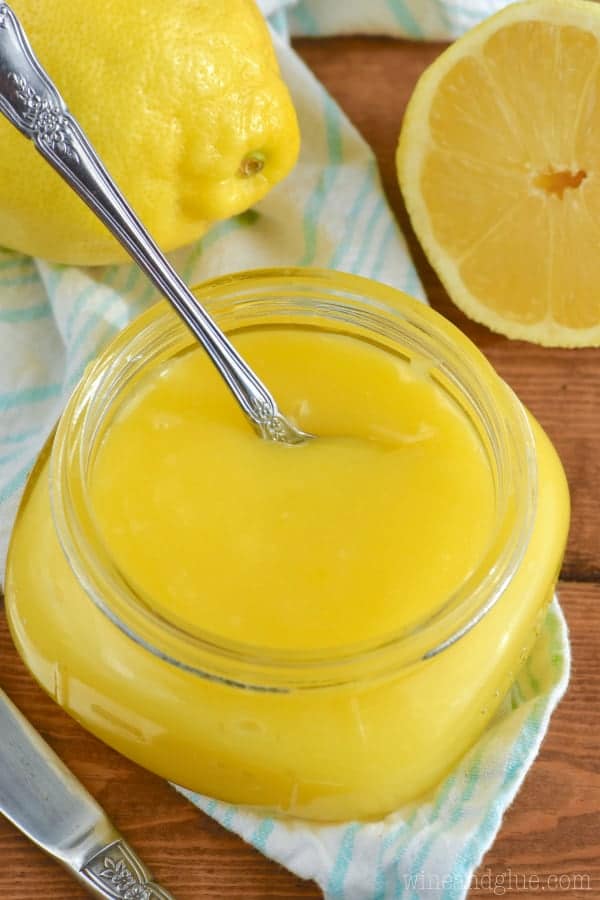 An overhead photo of the glossy lemon curd in the small jar. 