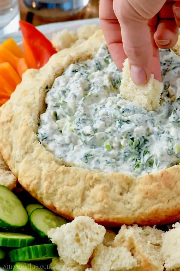 The Spinach dip is in the Beer Bread Dip Bowl and surrounded with vegetables. 