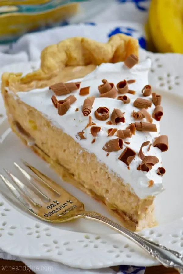 A slice of the Black Bottom Banana Peanut Butter Pie has three distinct fillings starting with the chocolate ganache at the bottom, the creamy Banana Peanut Butter middle, and whipped cream topping with shaved chocolate. 