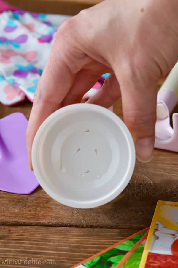 Some holes are punctured at the bottom of the Yoplait yogurt cup. 