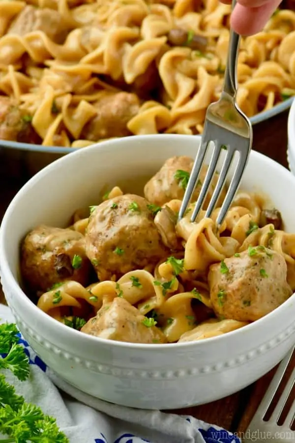 fast and easy stroganoff recipe in a white bowl being forked