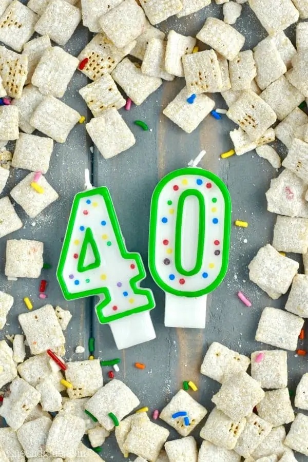 An overhead photo of birthday candles with the numbers 40 surrounded by the Funfetti Cake Batter Muddy Buddies. 