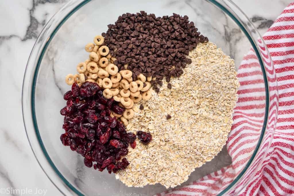 overhead of a bowl of quick cooking oats, dried cranberries, cherrie-os and mini chocolate chips