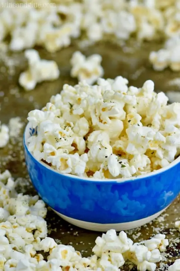 In a blue bowl, the Italian Popcorn has dry basil and dry parsley. 