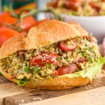 Close up photo of Pesto Chicken Salad served on a croissant. - 8