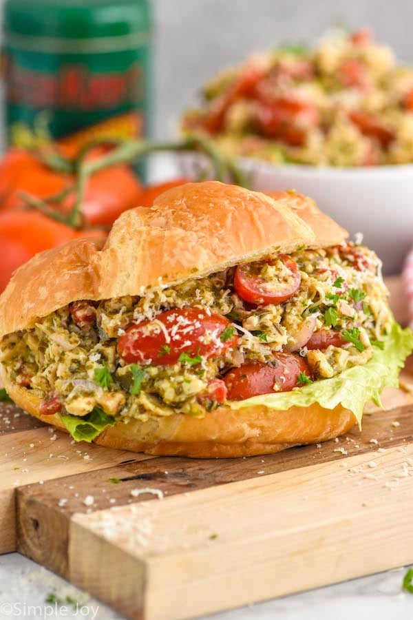 Close up photo of Pesto Chicken Salad served on a croissant.