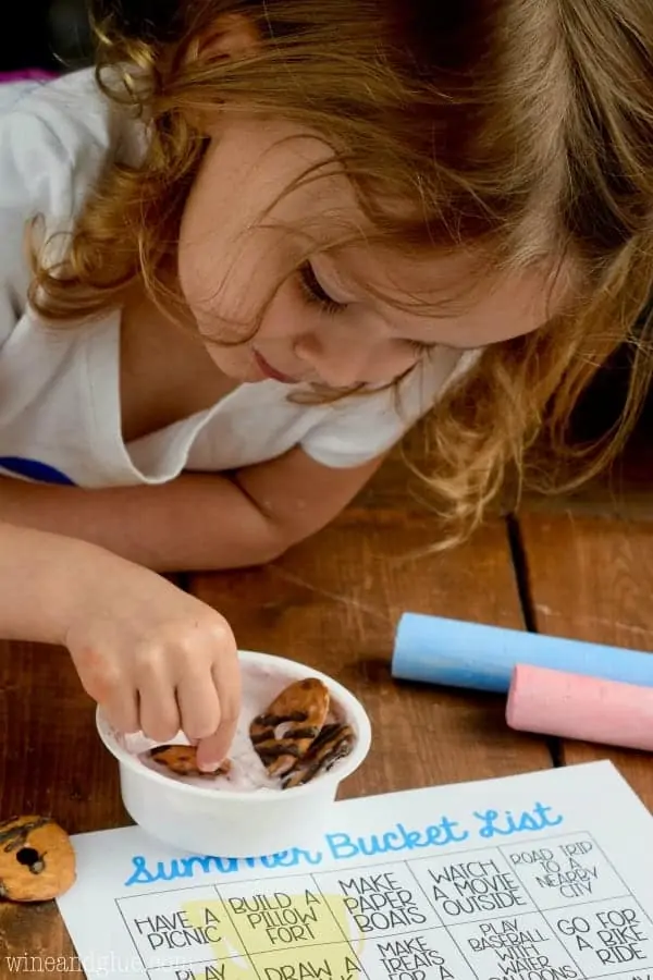 A little girl dipping the cracker from the Yoplait Dippers