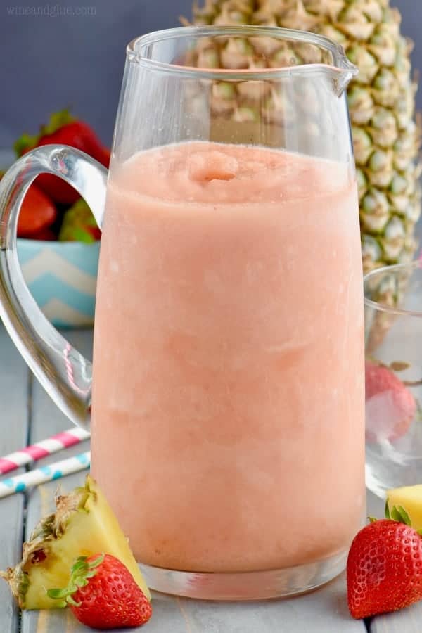 A large pitcher of the Frozen Sangria Slush with a beautiful cotton candy pink color. 