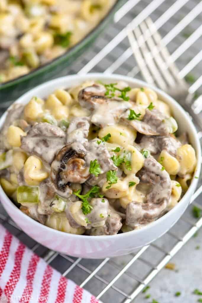 small white bowl of macaroni and cheese with ingredients to make it like a Philly cheesesteak