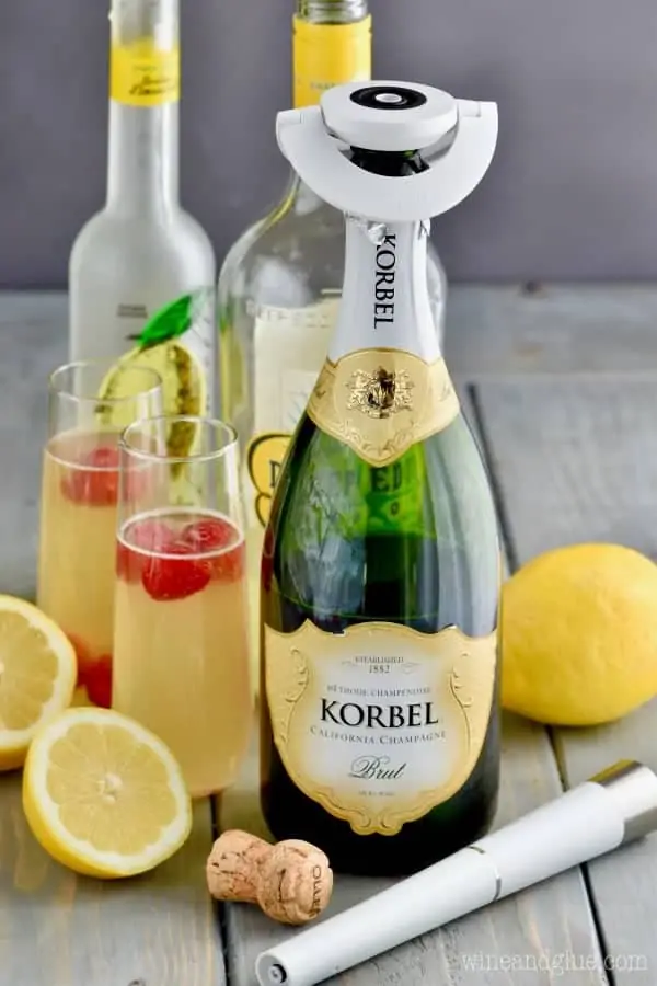 The ingredients of the Lemon Champagne Cocktail is shown (limocello, lemon vodka, and champagne.)