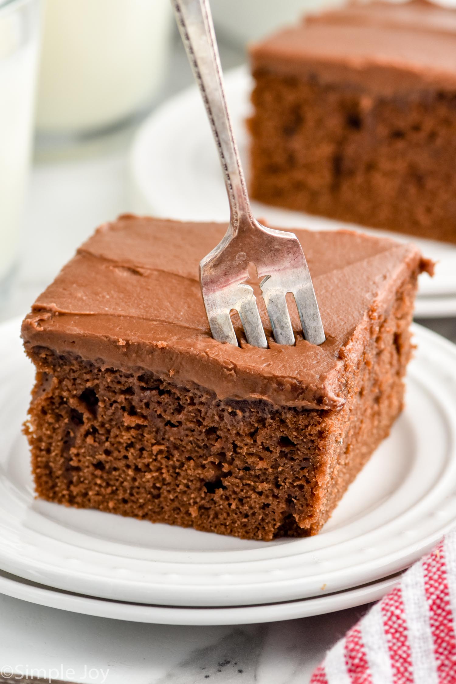 fork coming down into a piece of chocolate cake