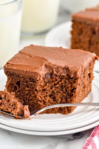 easy chocolate cake on a plate with a bite missing