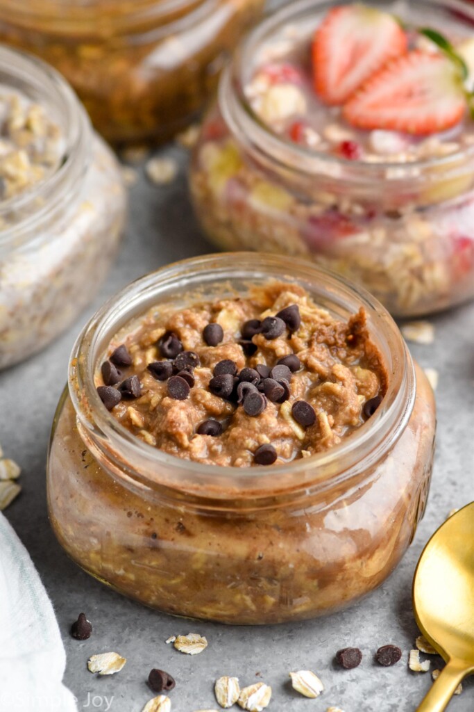 small mason jar full of chocolate peanut butter overnight oats, with mini chocolate chips on top