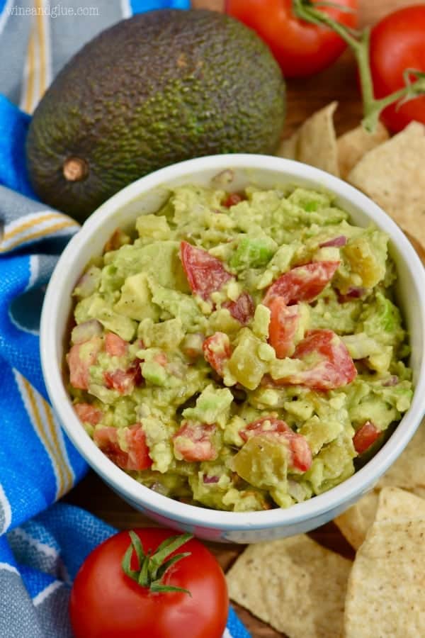 Overhead view of the best guacamole recipe in a bowl surrounded with tortilla chips