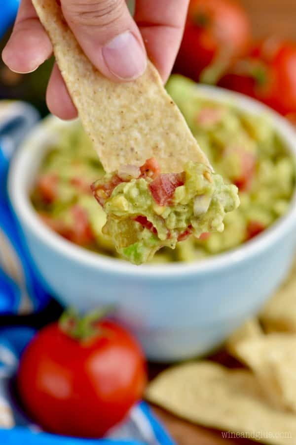 tortilla chip strip with the best guacamole recipe on the end of it