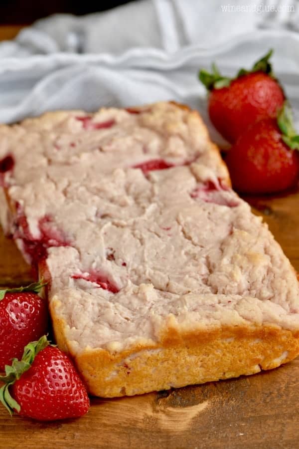 The Three Ingredient Yogurt Bread has a beautiful golden brown crust with spots of red from strawberries 