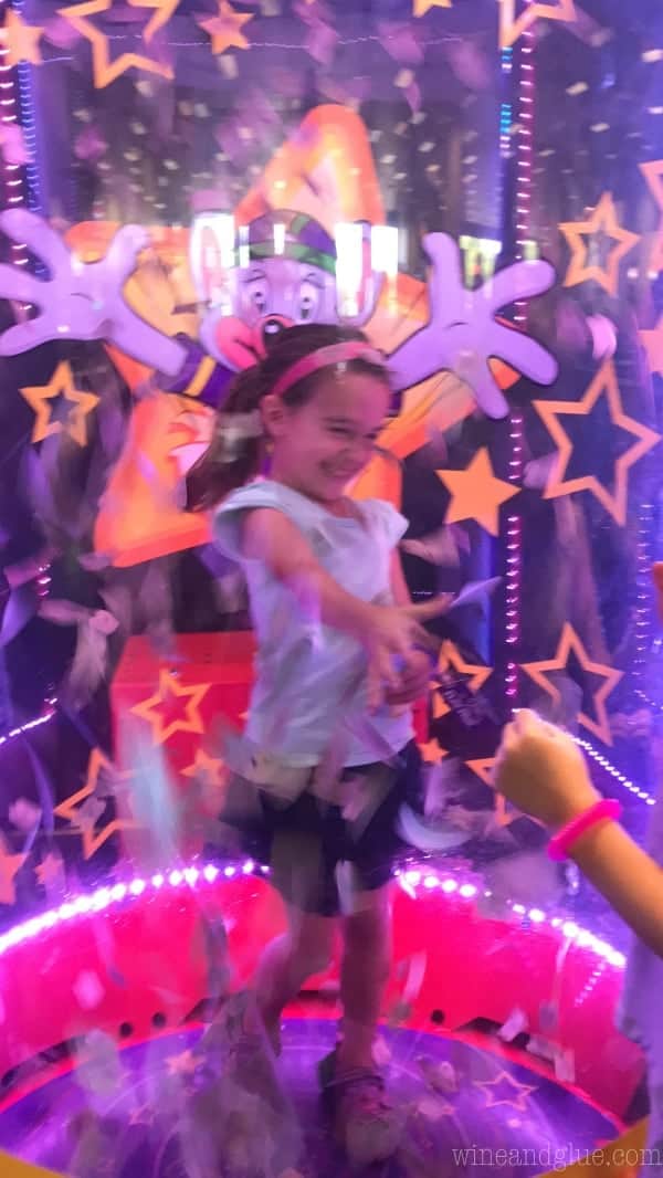 A little girl in the ticket blaster trying to grab as many as tickets possible 