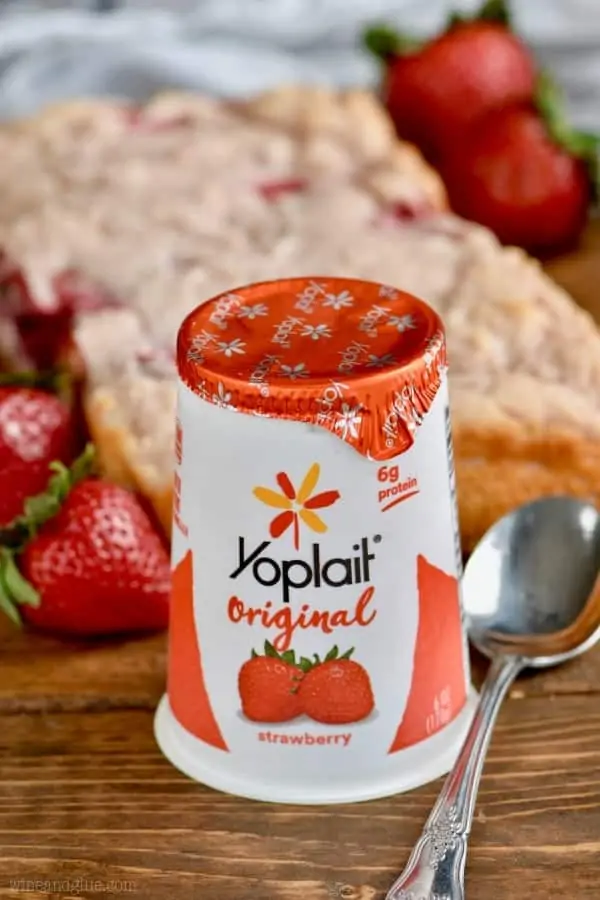 Yoplait's original strawberry yogurt is in front of the Three Ingredient Yogurt Bread