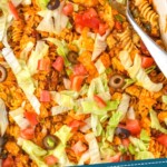 pinterst graphic of overhead of a casserole full of taco casserole bake that says: "tried and tested taco casserole simplejoy.com"