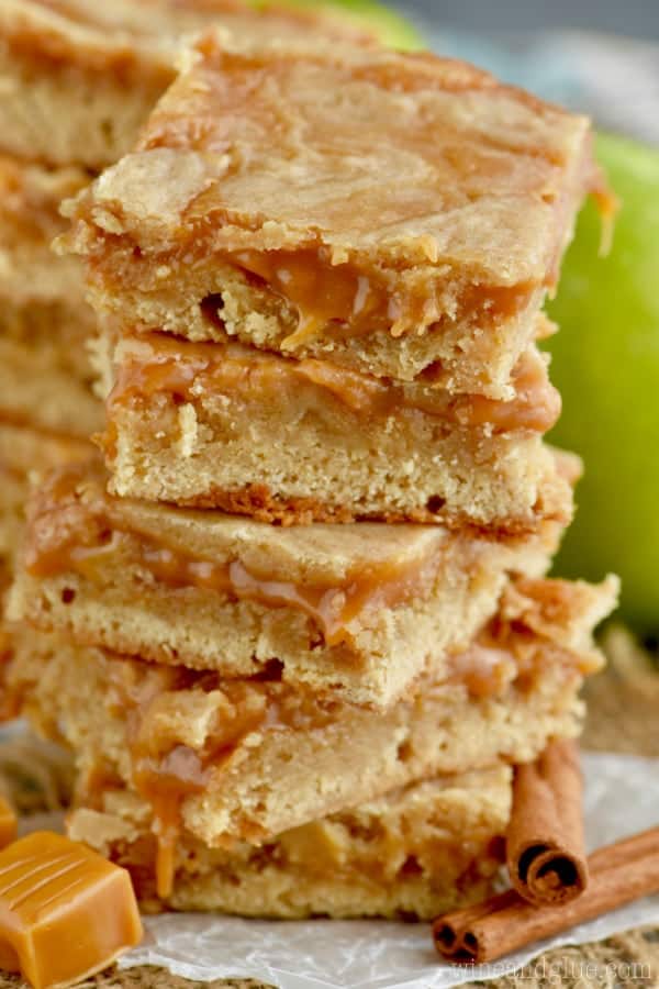 A stack of the Caramel Apple Bars with caramel swirled into and oozing out of the bars. 