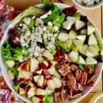 overhead view of fall salad with cut up apples, pears, blue cheese, and pecans