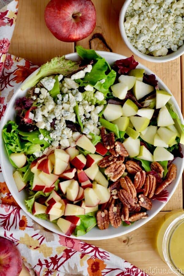 overhead view of fall salad with cut up apples, pears, blue cheese, and pecans