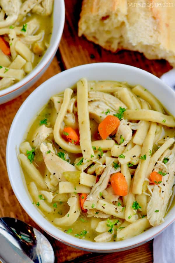 An overhead photo of the Homemade Chicken Noodle Soup with shredded chicken, noodles, celery, and carrots. 