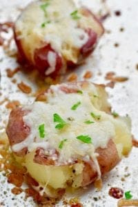 These Italian Roasted Smashed Potatoes are easy, loaded with garlic, butter, and cheese, and seasoned perfectly.  They are a great side dish for any night because they involve so little hands on time!